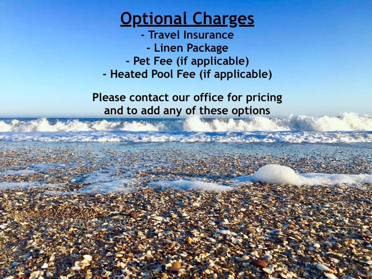 A serene view of rolling ocean waves, a shell-strewn sandy beach, and a clear blue sky. The natural beauty and inviting shoreline create a tranquil atmosphere, perfect for long walks and quiet reflection.
